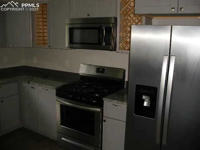 a kitchen with a stainless steel appliances and cabinets
