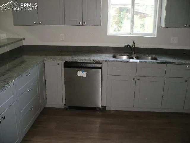 a kitchen with granite countertop white cabinets and sink