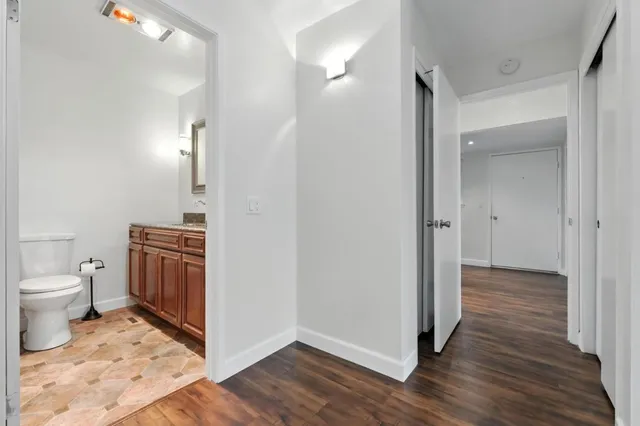 a view of bathroom with a toilet a sink and a mirror