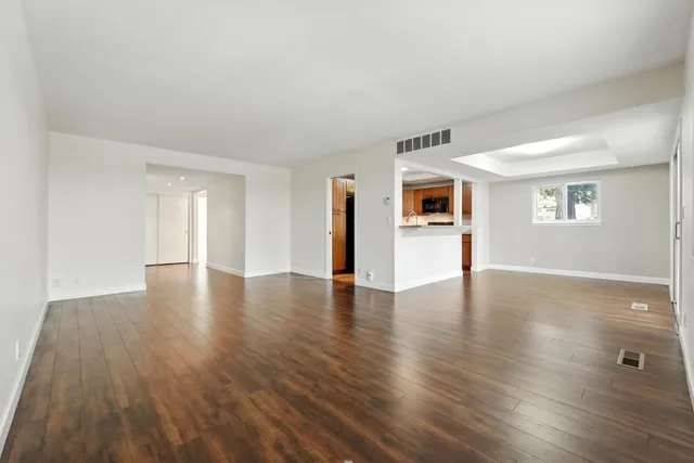 a view of a livingroom with wooden floor and window