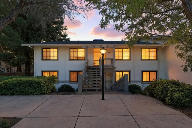 a front view of a residential apartment building with a yard