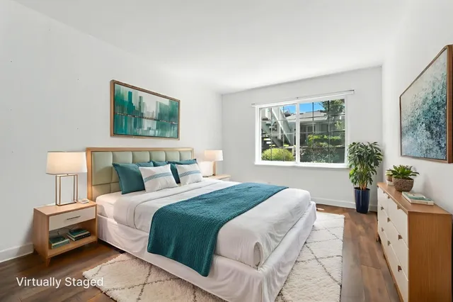 a bedroom with a large bed and a window