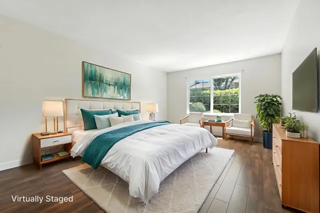 a bedroom with bed couch and window