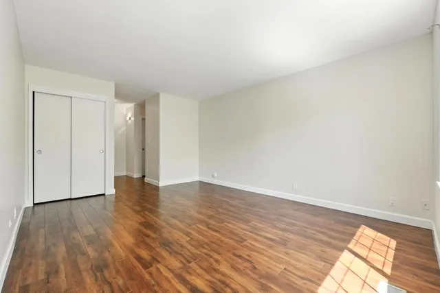 a view of an empty room and wooden floor