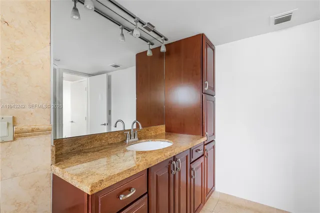 a view of closet with wooden floor