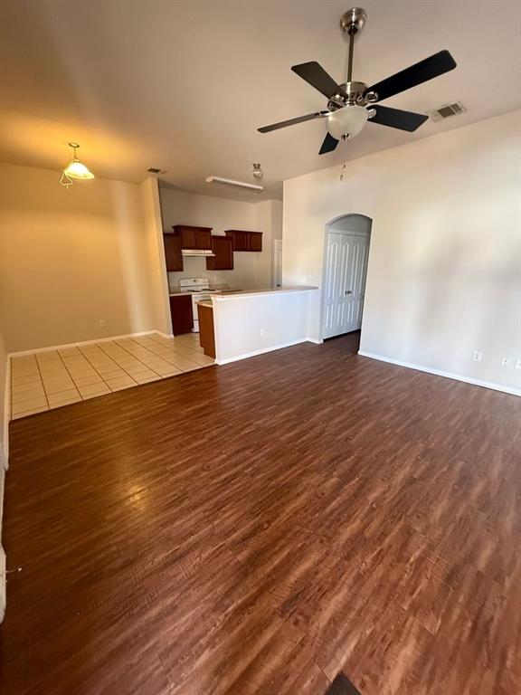 5540 Homestead Road Arlington, TX 76017 - Photo 3 of 11 a view of a kitchen with a dishwasher and wooden floor