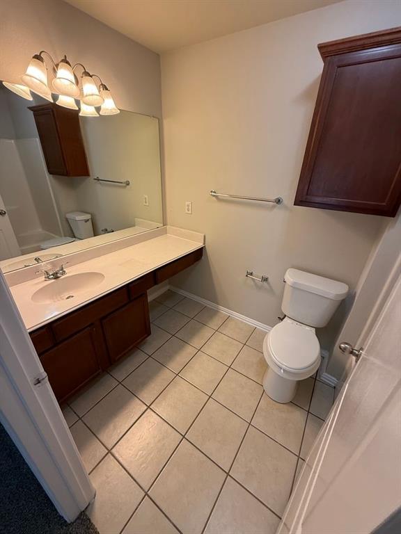 5540 Homestead Road Arlington, TX 76017 - Photo 6 of 11 a bathroom with a sink mirror vanity and toilet