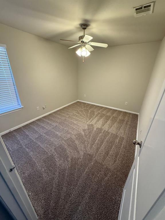 5540 Homestead Road Arlington, TX 76017 - Photo 7 of 11 a view of a room with a ceiling fan and a hardwood