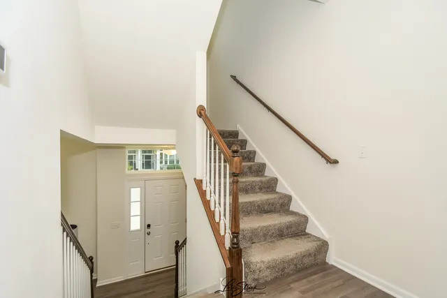 a view of entryway and hall with wooden floor