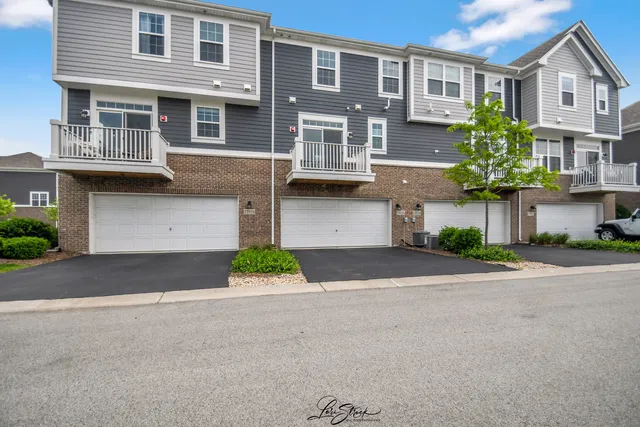 a front view of a building with a yard and a garage
