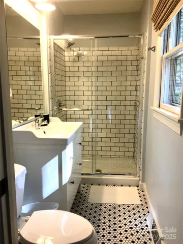 a bathroom with a sink toilet and mirror