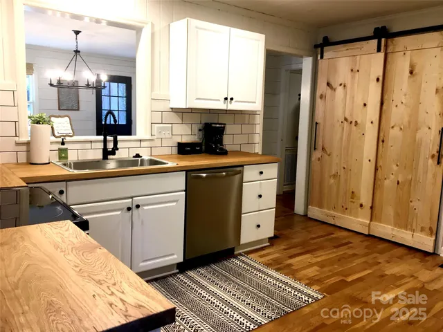 a kitchen with a sink cabinets and wooden floor