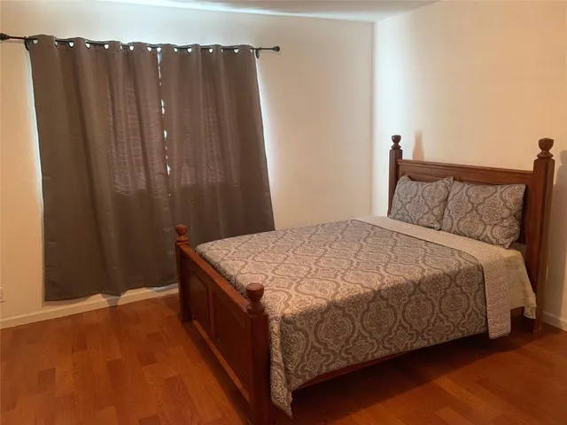a bed sitting in a bedroom next to a wooden door