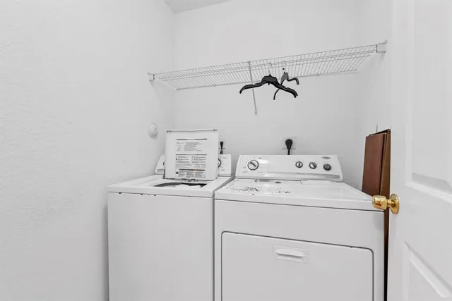 a view of a room with gym equipment and wooden floor