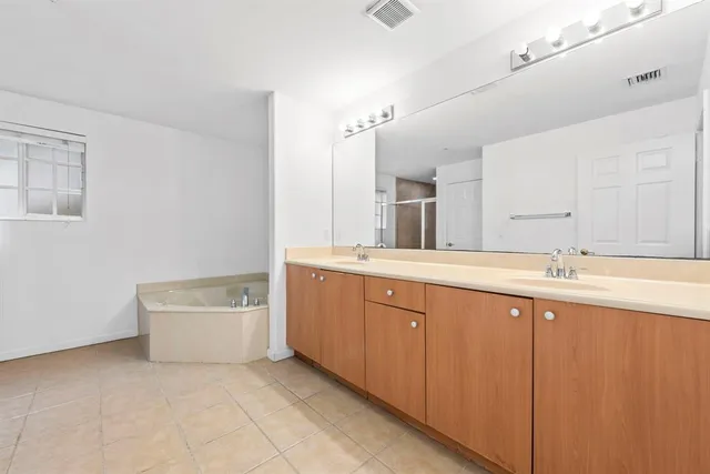 a bathroom with a shower and a glass door