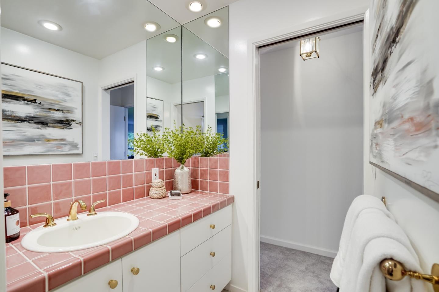 1238 Park Pacifica Avenue Pacifica, CA 94044 - Photo 21 of 32 a bathroom with a sink and a mirror