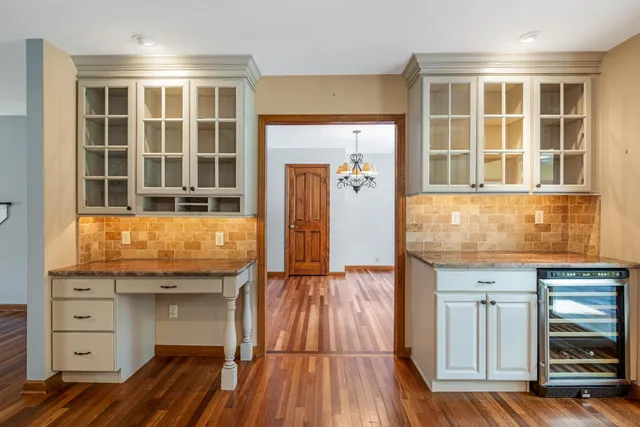 a view of kitchen with granite countertop cabinets and wooden floor