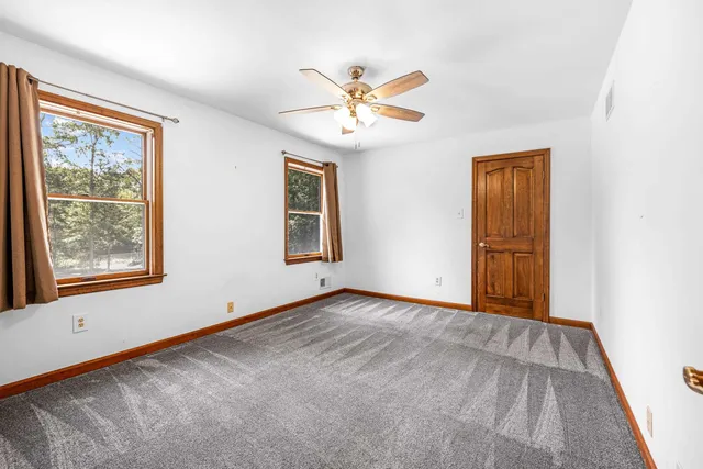 a view of empty room with ceiling fan