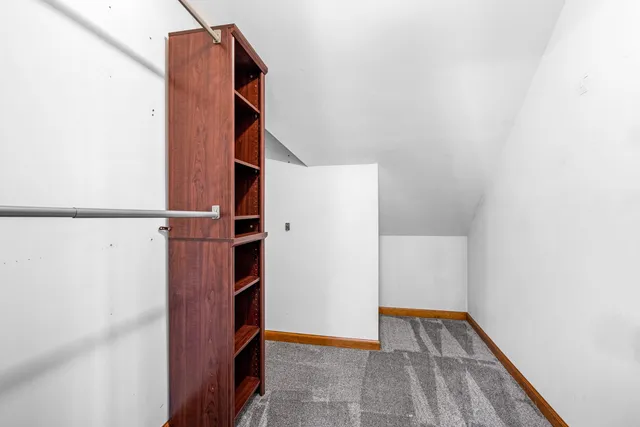 an empty room with closet and a ceiling fan