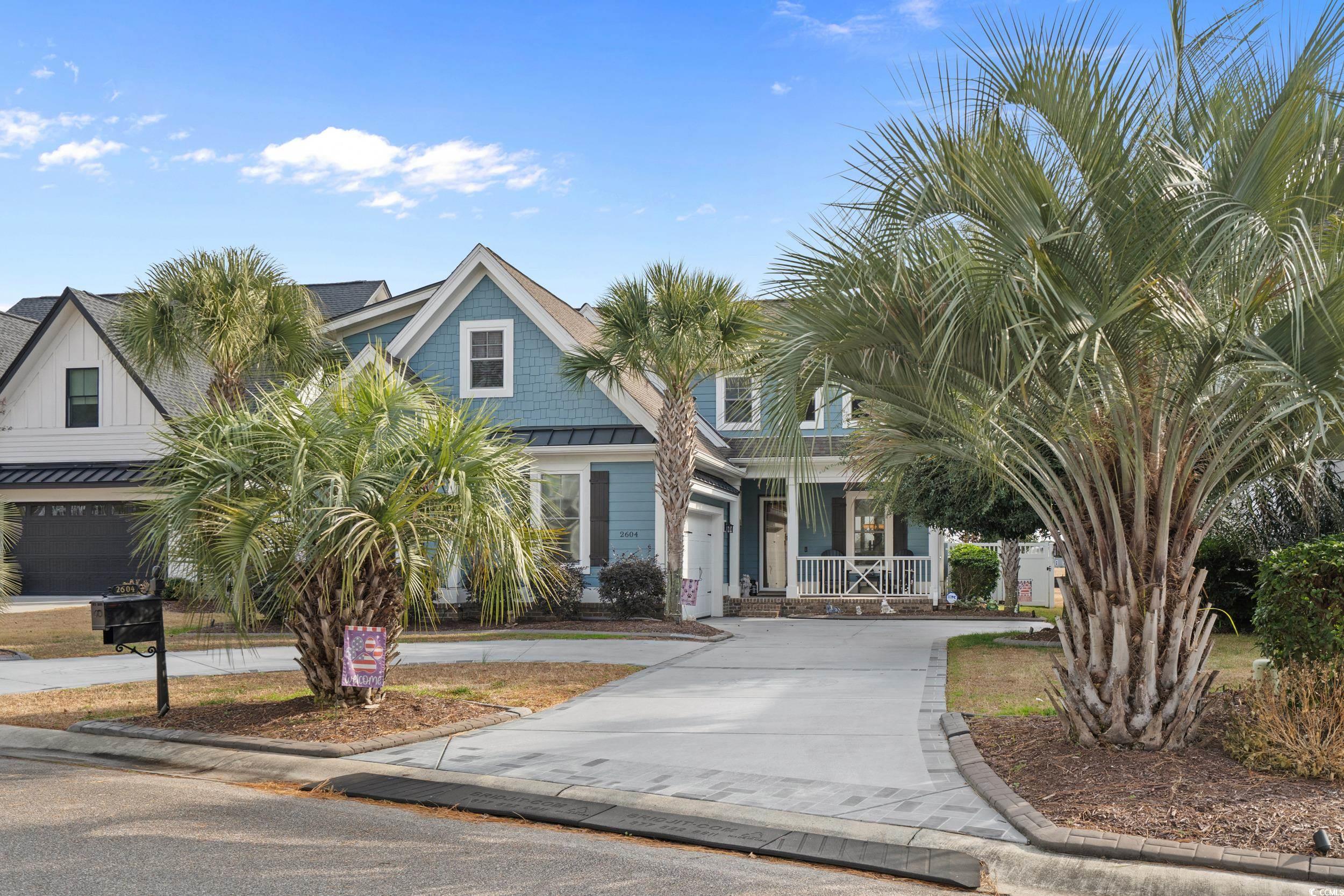 2604 Painted Trillium Court Myrtle Beach, SC 29579 - Photo 33 of 40 View of front of house with concrete driveway, a standing seam roof, and a metal roof