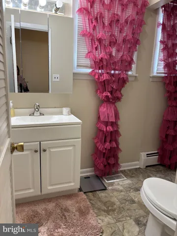 a bathroom with a toilet sink and mirror