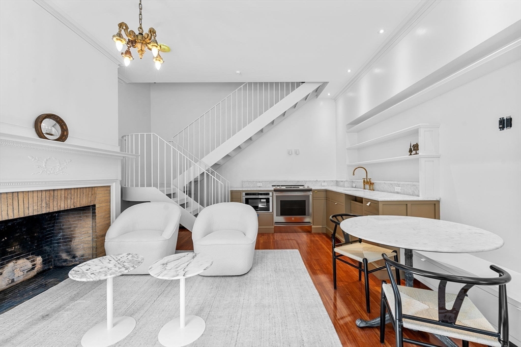 320 Tappan Street, Unit 1 Brookline, MA 02445 - Photo 3 of 10 a living room with furniture a fireplace and a table