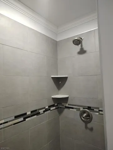 a bathroom with a granite countertop sink a toilet and a shower