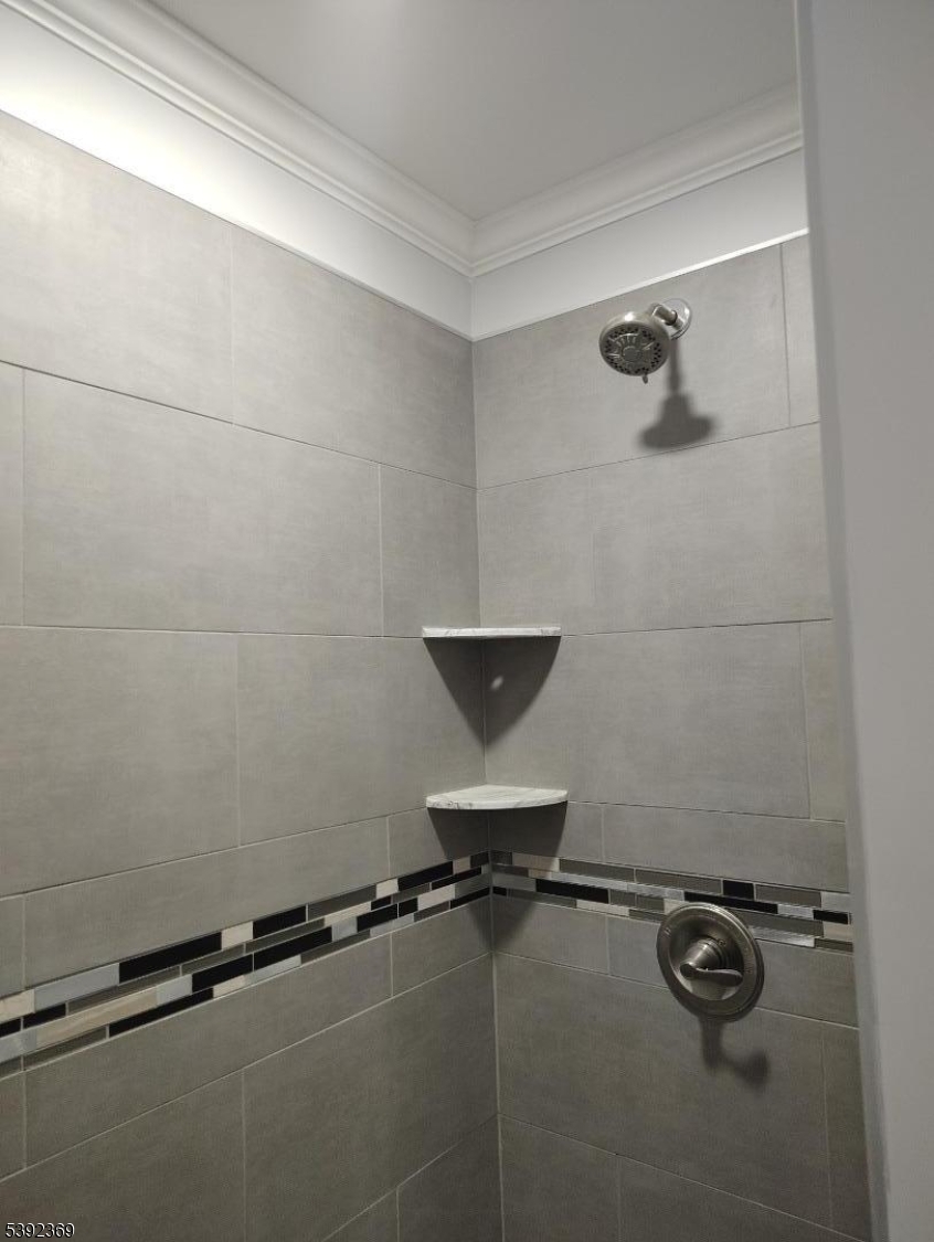 54 East Maple Street Teaneck, NJ 07666 - Photo 6 of 17 a bathroom with a granite countertop sink a toilet and a shower