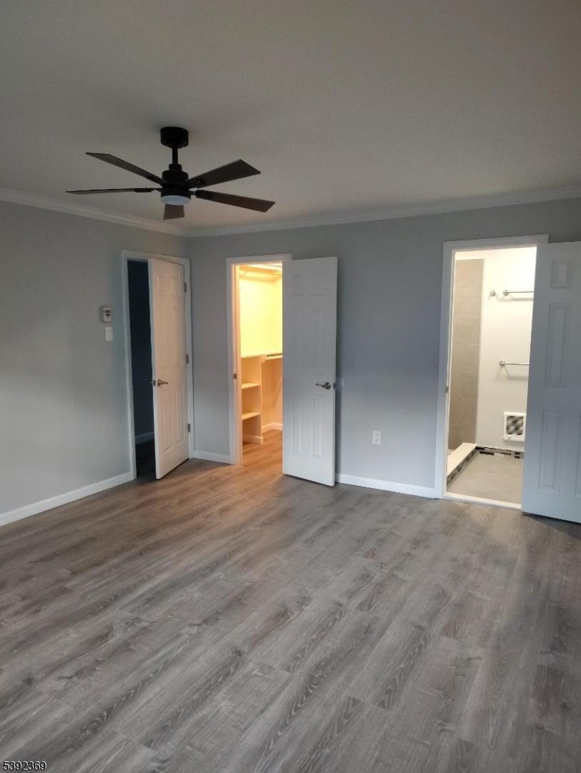 54 East Maple Street Teaneck, NJ 07666 - Photo 8 of 17 a view of an empty room with a window and a ceiling fan