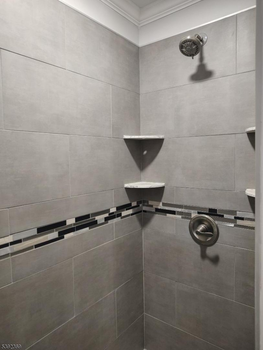 54 East Maple Street Teaneck, NJ 07666 - Photo 10 of 17 a bathroom with a window and a bath tub