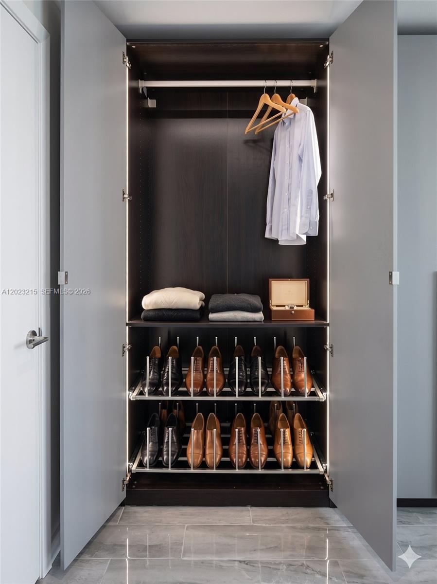 13 Southwest 3rd Street, Unit 13 Pompano Beach, FL 33060 - Photo 31 of 44 a view of walk in closet with clothes and shoes