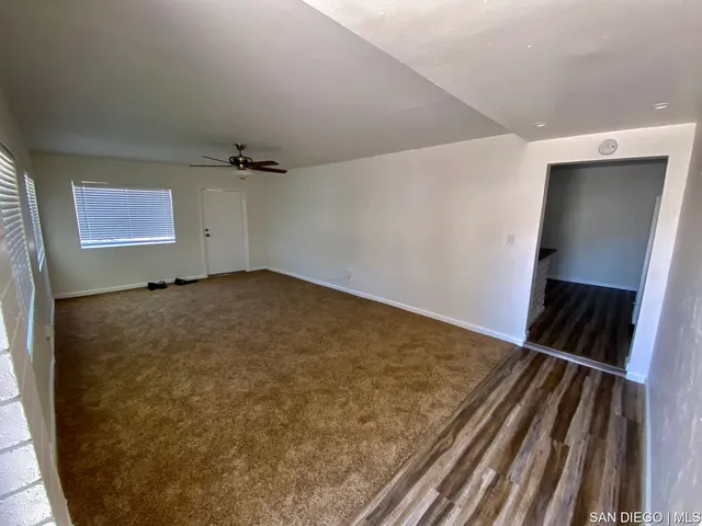 a view of livingroom with hallway and wooden floor