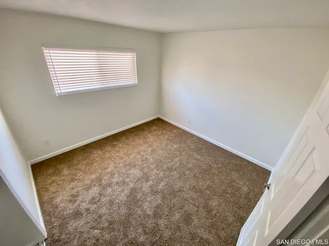 a white toilet sitting next to a bathroom sink and tub