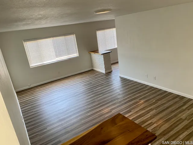 a view of an empty room with windows