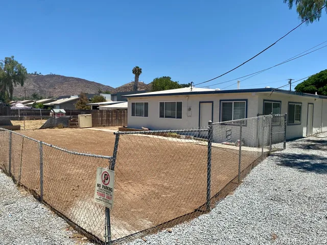 a view of a white house with large windows