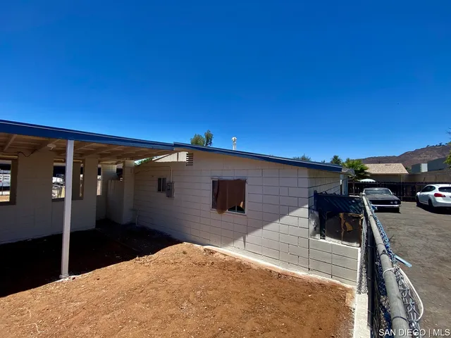 a backyard of a house with cars parked
