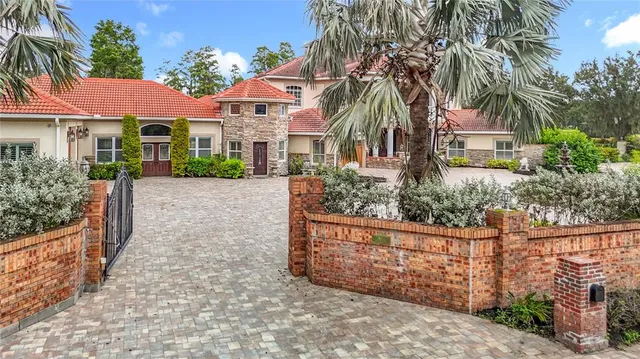 a view of a livingroom with wooden floor and a kitchen space