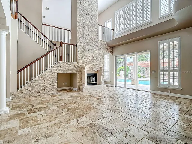 a view of an empty room with closet and a window