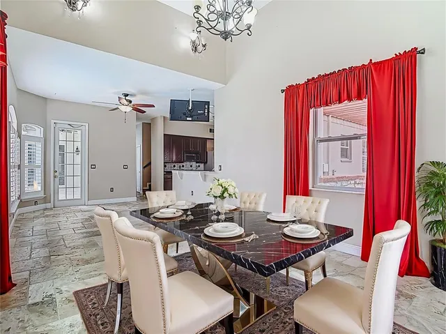 a view of a patio with table and chairs under an umbrella