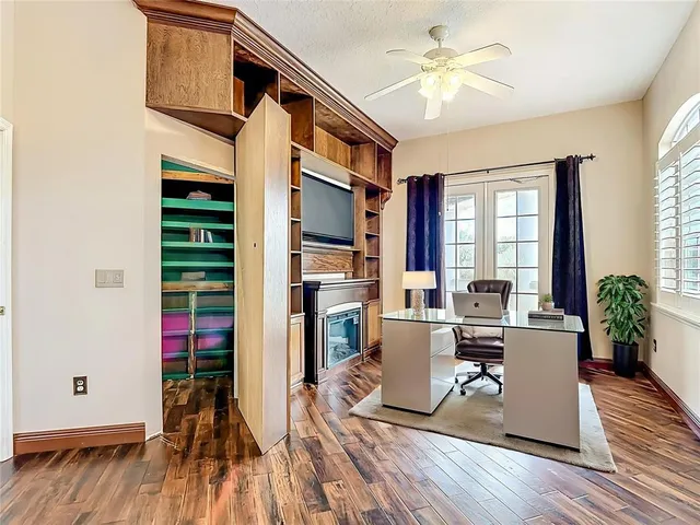 a view of an empty room with a fireplace and a window