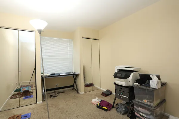 a living room with furniture a piano and a window