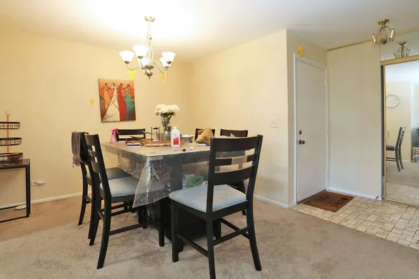 a view of a dining room with furniture and chandelier