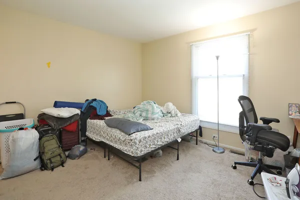 a bedroom with furniture and a window