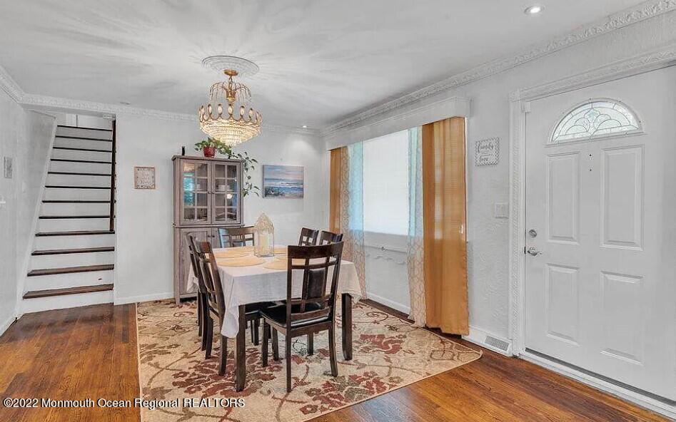 524 Lloyd Road Matawan, NJ 07747 - Photo 4 of 25 a view of a dining room with furniture wooden floor and chandelier