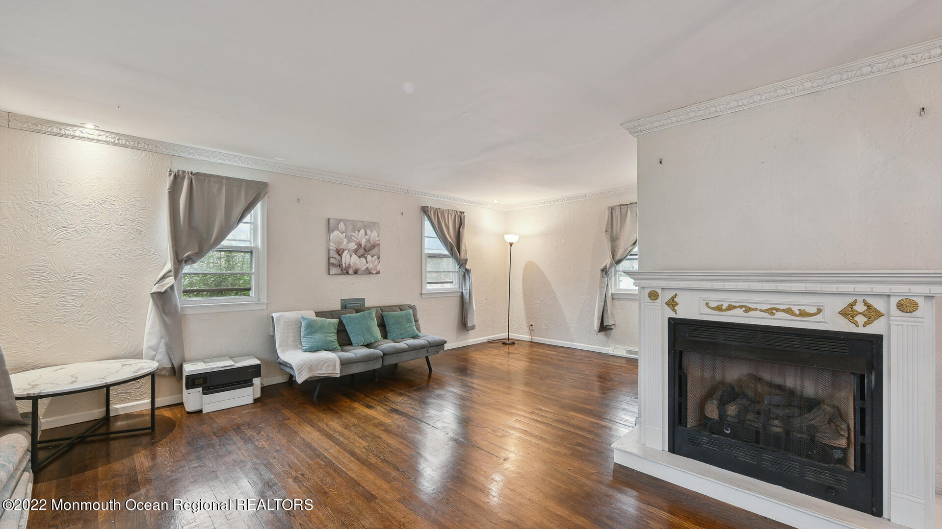 524 Lloyd Road Matawan, NJ 07747 - Photo 6 of 25 a living room with furniture and a fireplace
