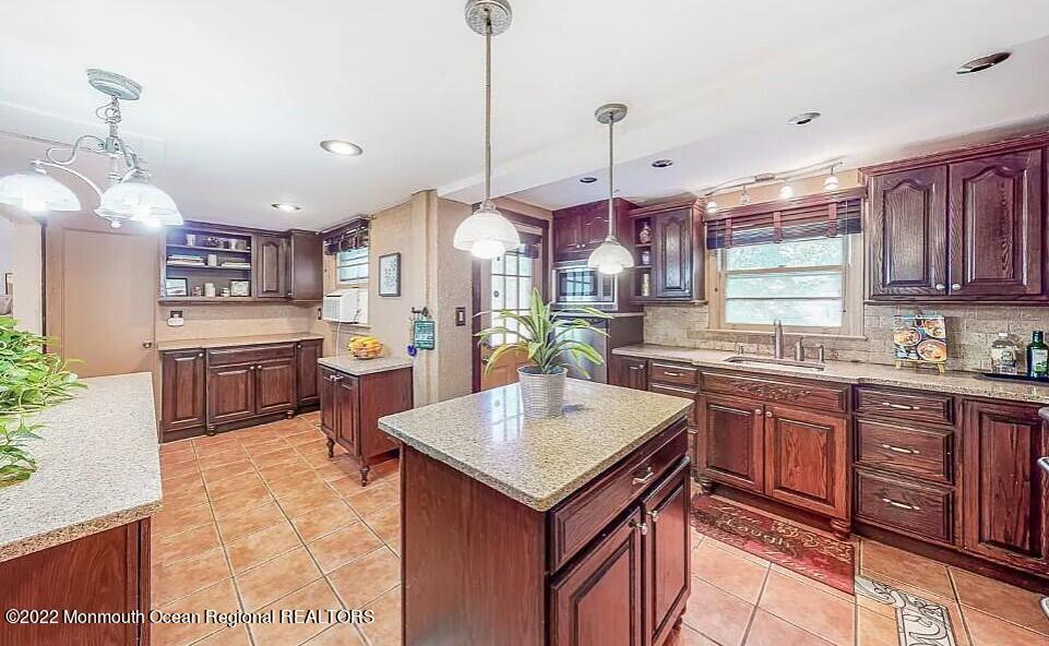 524 Lloyd Road Matawan, NJ 07747 - Photo 8 of 25 a kitchen with stainless steel appliances granite countertop a sink a stove and a wooden floors