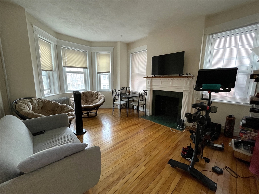 5 Spofford Road, Unit 11 Boston, MA 02134 - Photo 11 of 14 a living room with furniture flat screen tv and a fireplace