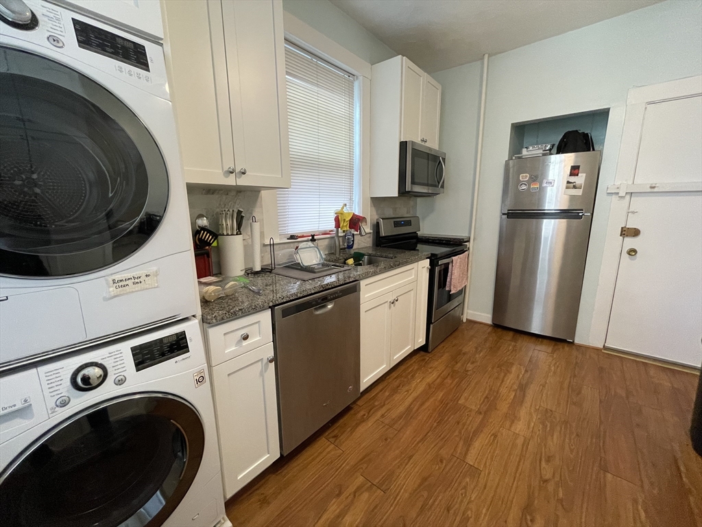 5 Spofford Road, Unit 11 Boston, MA 02134 - Photo 3 of 14 a kitchen with a sink a refrigerator and cabinets