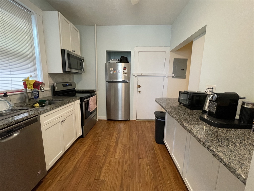 5 Spofford Road, Unit 11 Boston, MA 02134 - Photo 4 of 14 a kitchen with granite countertop a refrigerator stove top oven and sink