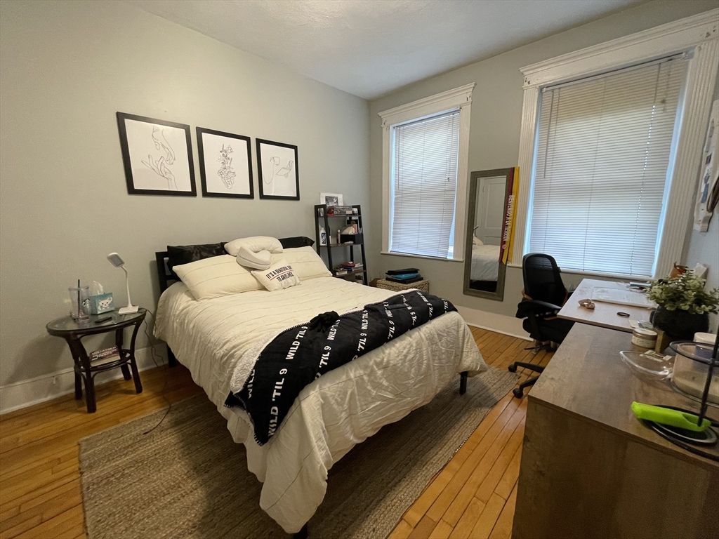 5 Spofford Road, Unit 11 Boston, MA 02134 - Photo 5 of 14 a bedroom with a bed a mirror and a potted plant on dresser